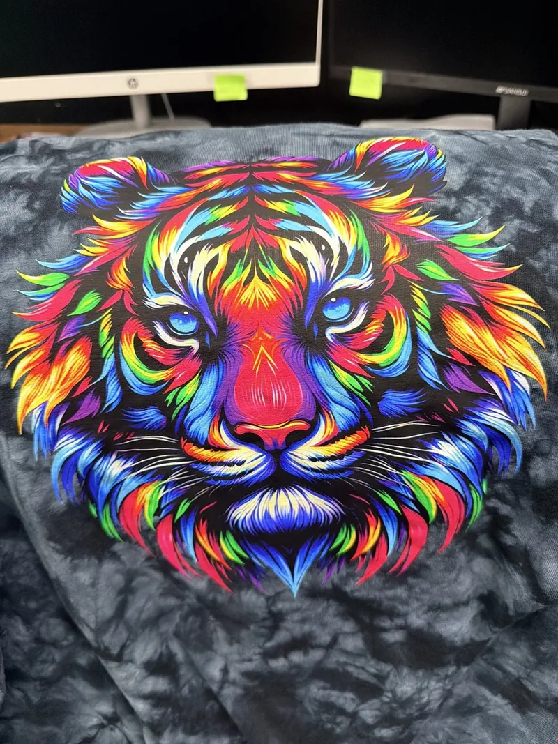 Rainbow tiger DTF transfer pressed on a dark tie-dye shirt